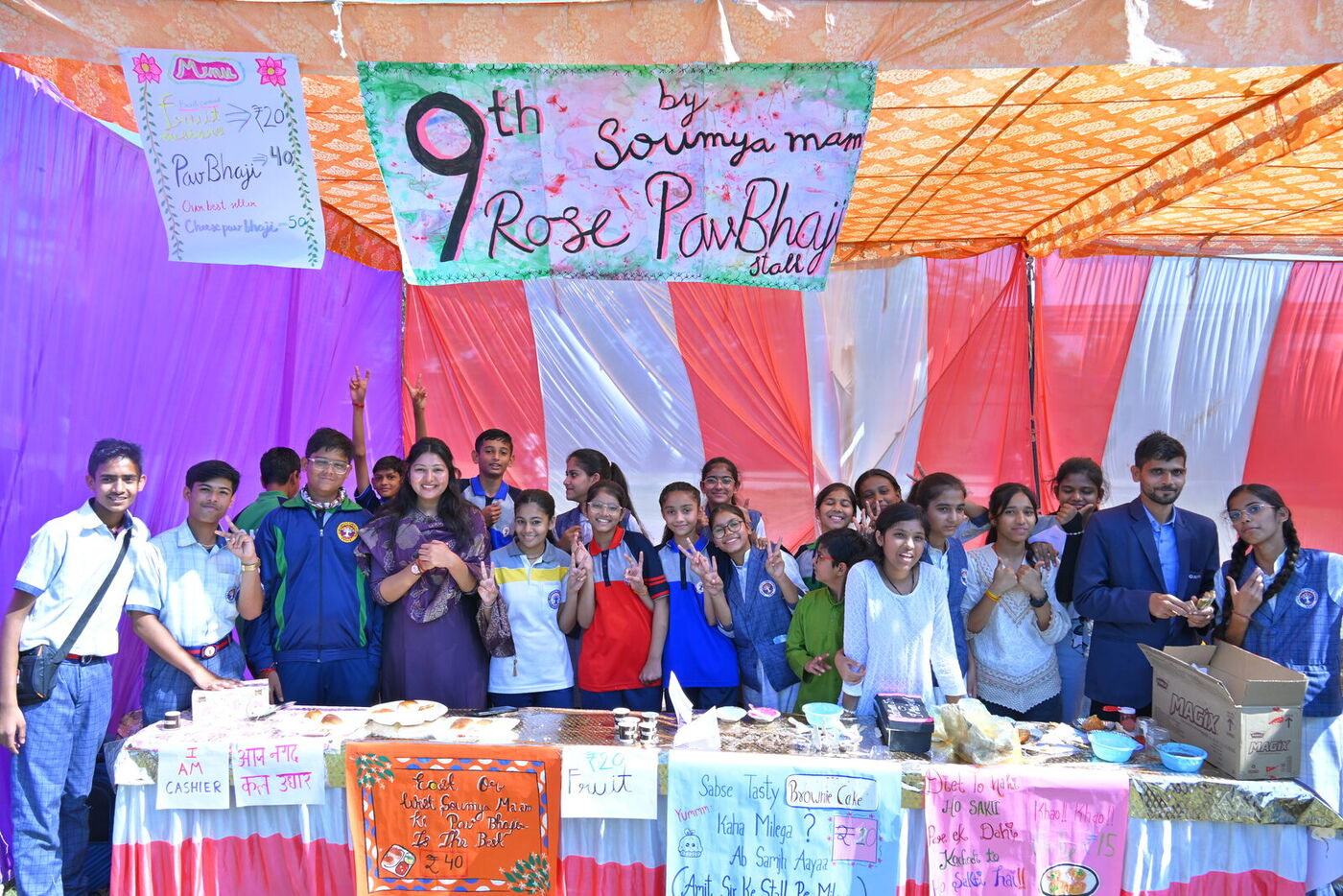 Class 9 students at their decorated food stall during the Children's Day fair