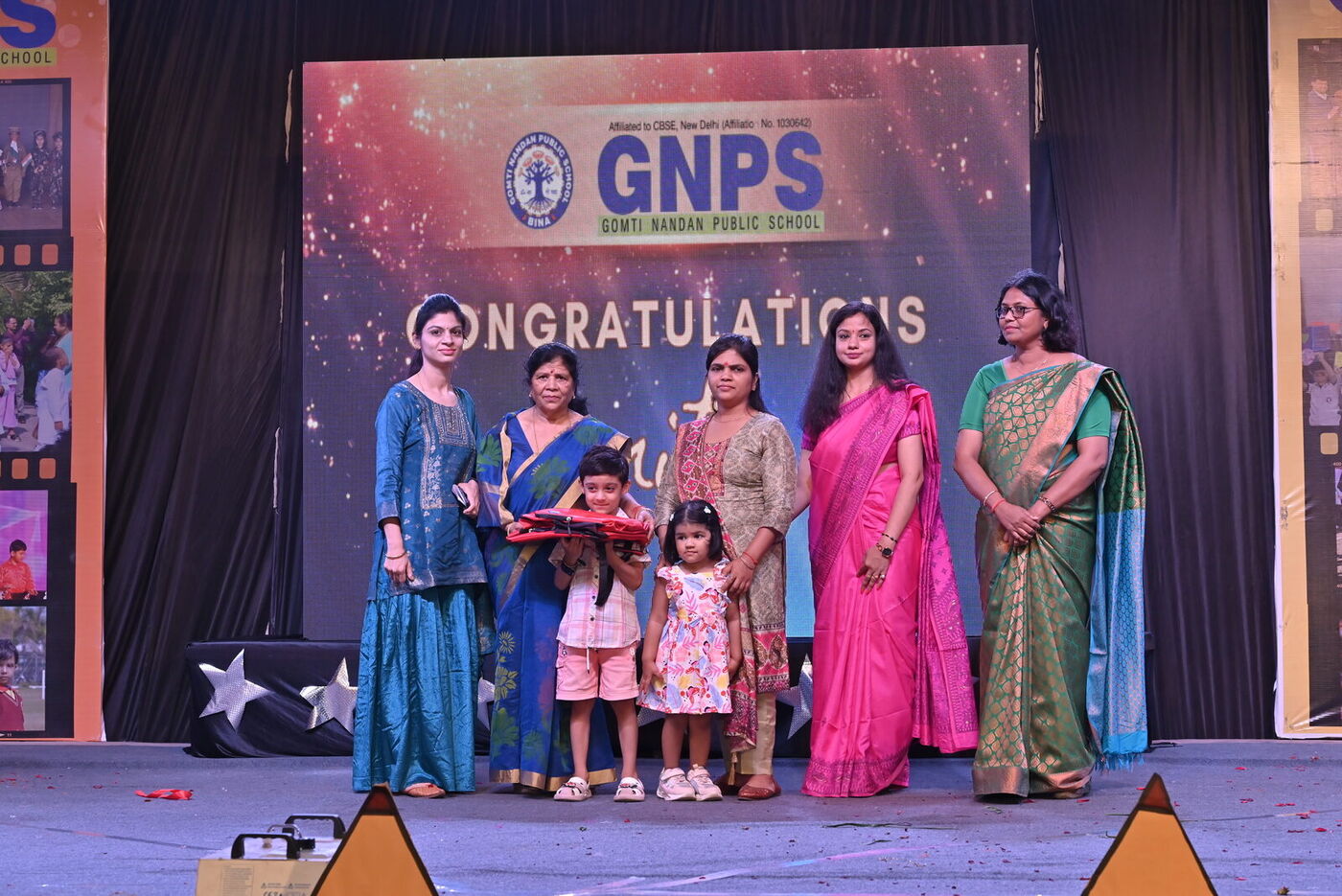 Teachers and guests present certificates to young graduates at the Graduation Day 2026 ceremony
