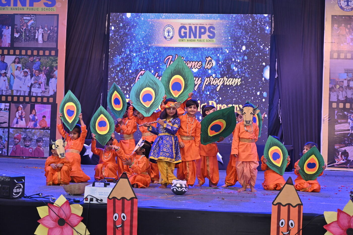 Kindergarten children perform a colourful peacock-feather dance on stage at the GNPS Graduation Day 2026 programme