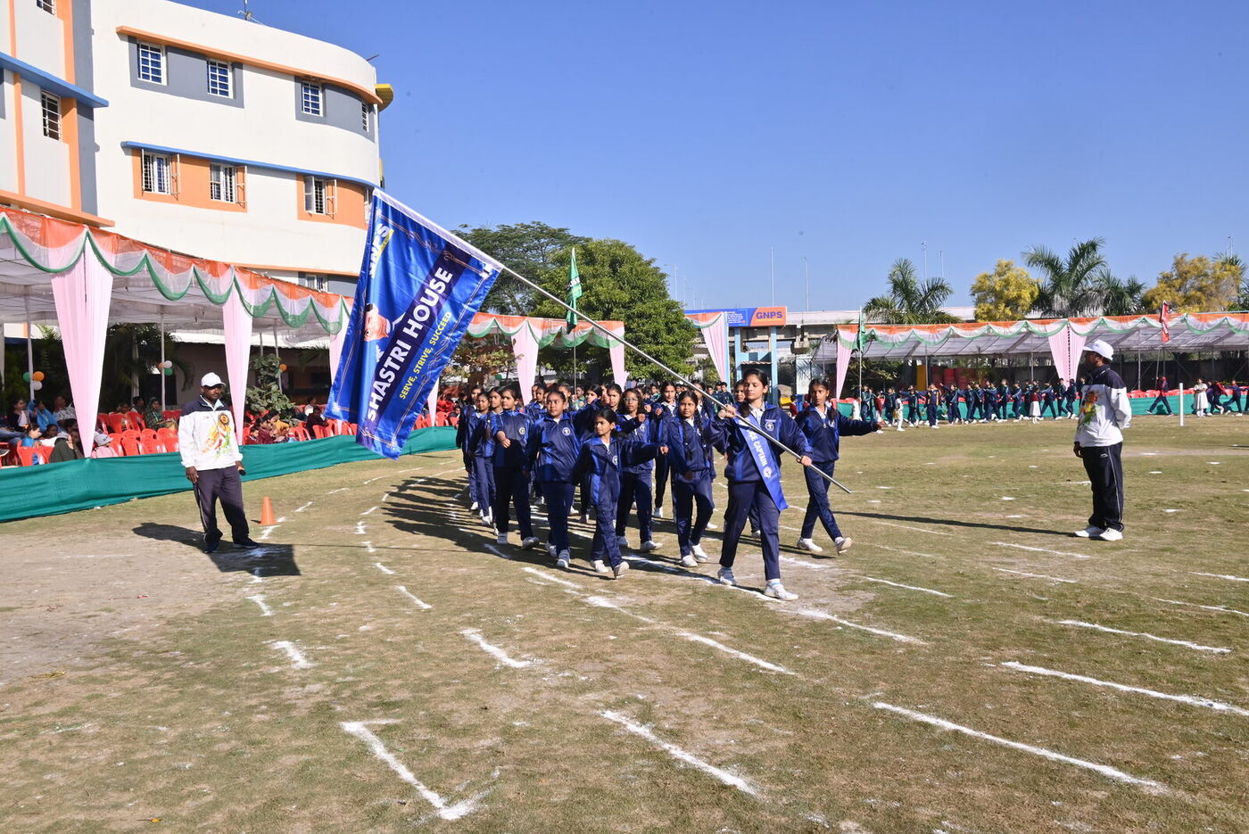 Shastri House marches past carrying its house flag