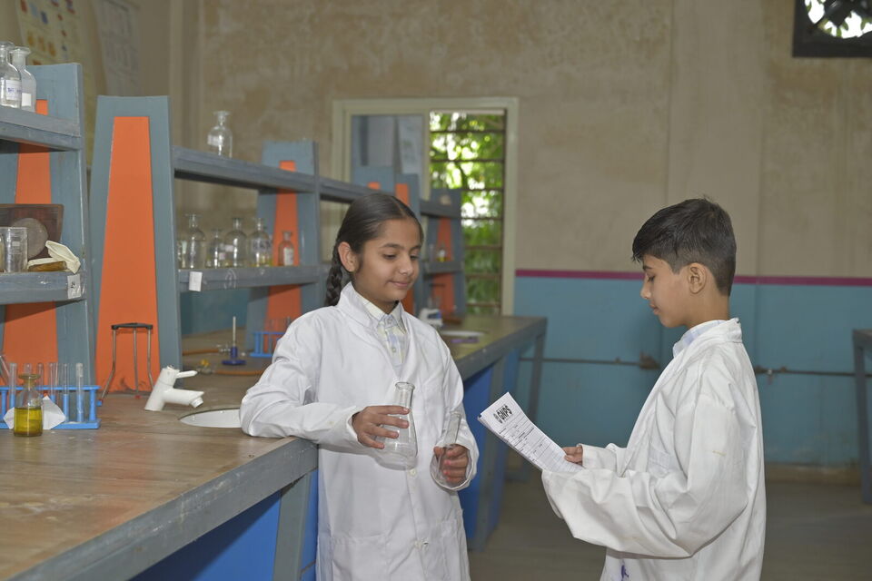 Two students carry out an experiment in the science lab